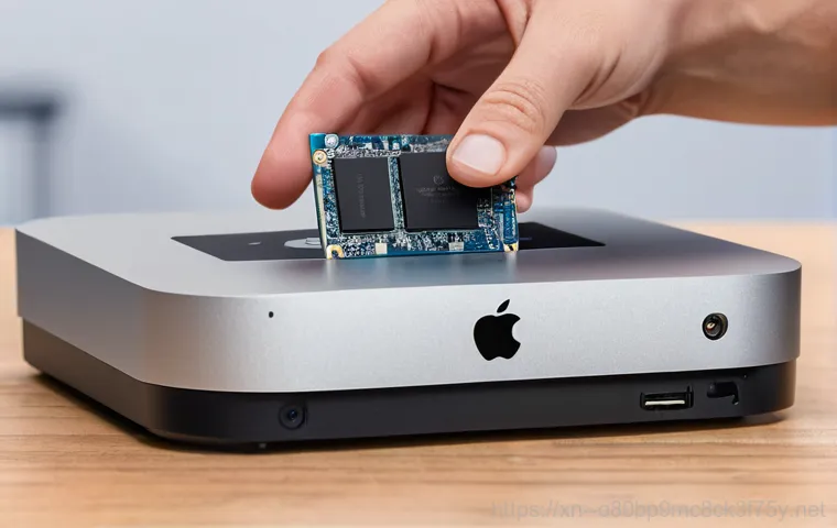 남사면 맥미니 판매 및 수리 - A close-up, professional shot of an opened Apple Mac Mini during a technical repair. The internal co...