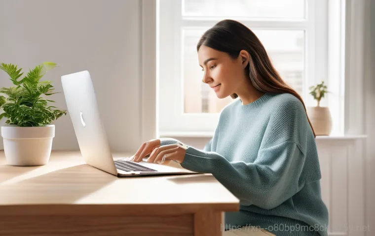 신현원창동 맥북프로 판매 및 수리 - A focused young adult technician, wearing a clean, modern workshop apron over a casual shirt and tro...