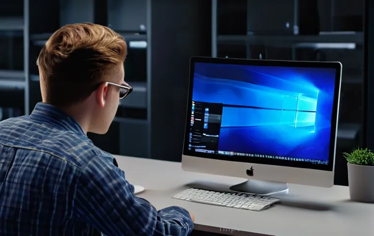 오성면 맥윈도우 부트캠프_bootcamp 재설치 포맷  초기화 - A young adult, gender-neutral, sits at a modern desk, looking visibly frustrated at their MacBook Pr...
