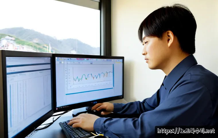 교남동 STATUS_KERNEL_MEMORY_LEAK - Photorealistic IT support workstation in a compact hillside neighborhood office, dual monitors showi...