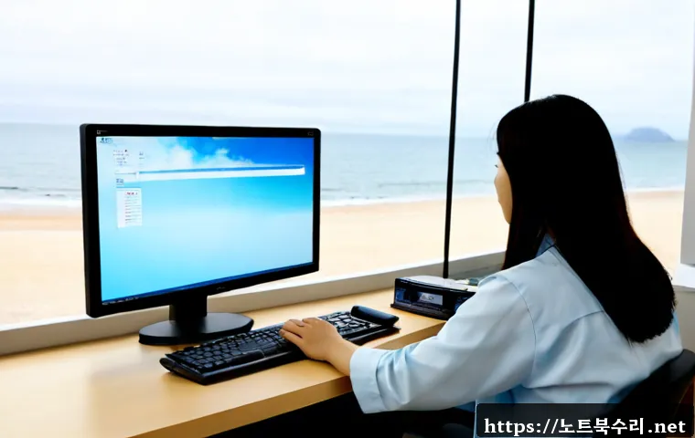 을왕동 FAT_FILE_SYSTEM - Photorealistic remote IT support workstation overlooking a quiet west-coast beach through wide windo...